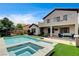 Inviting backyard with a refreshing pool, spa, covered patio, and outdoor seating area at 11 Morninglow Pass, Henderson, NV 89052
