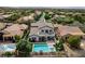 Backyard oasis featuring a sparkling pool and spa, ample outdoor seating, and lush landscaping for relaxation at 11 Morninglow Pass, Henderson, NV 89052