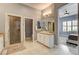 Bright bathroom featuring a glass shower, a vanity with marble countertop, and views into the bedroom at 11 Morninglow Pass, Henderson, NV 89052