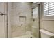 Modern bathroom with glass shower featuring marble-style tile at 11 Morninglow Pass, Henderson, NV 89052