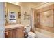 Well-lit bathroom with tiled shower-tub combination and neutral color palette at 11 Morninglow Pass, Henderson, NV 89052
