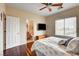 Bedroom features hardwood floors, a ceiling fan, and a mounted television at 11 Morninglow Pass, Henderson, NV 89052