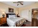 Bedroom features hardwood floors, a ceiling fan, closet, and a comfortable bed at 11 Morninglow Pass, Henderson, NV 89052