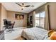 Bedroom with ceiling fan, study station, and neutral color palette at 11 Morninglow Pass, Henderson, NV 89052
