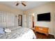 Bright bedroom showcasing hardwood floors, closet space, and a mounted television at 11 Morninglow Pass, Henderson, NV 89052