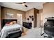 Bedroom with ceiling fan, gaming station, and adjacent bathroom at 11 Morninglow Pass, Henderson, NV 89052
