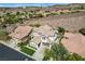 Stunning home showcasing manicured landscaping, desert backdrop, and convenient two-car garage for modern living at 11 Morninglow Pass, Henderson, NV 89052
