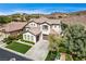 Beautiful home with lush green lawn, desert landscaping, and attached two-car garage, perfect for suburban living at 11 Morninglow Pass, Henderson, NV 89052