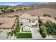 Charming two-story home features a well-manicured front yard, desert landscaping, and an attached two-car garage at 11 Morninglow Pass, Henderson, NV 89052