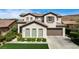 Charming two-story home with a manicured lawn and an attached two-car garage at 11 Morninglow Pass, Henderson, NV 89052