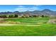 Expansive view of the golf course with rolling hills, sand traps, and mountain backdrop at 11 Morninglow Pass, Henderson, NV 89052