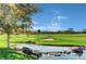 Beautiful golf course view with a water hazard and lush green fairways under a blue sky at 11 Morninglow Pass, Henderson, NV 89052