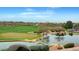 Picturesque golf course with a pond, manicured greens, and desert landscaping at 11 Morninglow Pass, Henderson, NV 89052