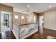 Bright hallway with hardwood floors, white banister staircase, and views to rooms throughout the home at 11 Morninglow Pass, Henderson, NV 89052