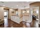Hallway features hardwood floors, white banister staircase, and views to rooms throughout the home at 11 Morninglow Pass, Henderson, NV 89052