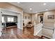 Bright hallway with hardwood floors, chair with ottoman, staircase and an open view to the living room at 11 Morninglow Pass, Henderson, NV 89052