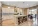 Bright kitchen with a center island, stainless steel appliances, and an adjacent dining area with views to the exterior at 11 Morninglow Pass, Henderson, NV 89052