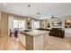Open-concept kitchen with an island bar overlooking a comfortable living area, ideal for modern living and entertaining at 11 Morninglow Pass, Henderson, NV 89052
