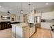 Modern kitchen with white cabinets, stainless steel appliances and an island at 11 Morninglow Pass, Henderson, NV 89052