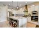 Bright kitchen featuring a center island with seating, stainless steel appliances, and modern lighting fixtures at 11 Morninglow Pass, Henderson, NV 89052