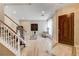 Inviting living room with a wooden front door and staircase, offering a comfortable and stylish entrance at 11 Morninglow Pass, Henderson, NV 89052
