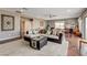 Spacious living room showcasing hardwood floors, a large sectional sofa, and natural light at 11 Morninglow Pass, Henderson, NV 89052