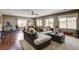 Bright and spacious living room with hardwood floors, large windows, and a cozy sectional couch at 11 Morninglow Pass, Henderson, NV 89052