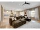Open-concept living area with a large sectional sofa, adjacent to the kitchen and dining area at 11 Morninglow Pass, Henderson, NV 89052