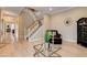 Open-concept living room with a staircase, hardwood floors, and stylish decor, providing a welcoming space at 11 Morninglow Pass, Henderson, NV 89052