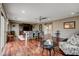 Bright living room featuring hardwood floors, a dining table, and a comfortable seating area at 11 Morninglow Pass, Henderson, NV 89052