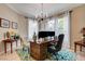 Spacious home office with ample natural light, a large desk, and comfortable seating, perfect for remote work at 11 Morninglow Pass, Henderson, NV 89052