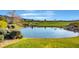 Peaceful view of a community pond adjacent to a lush green golf course with sand traps at 11 Morninglow Pass, Henderson, NV 89052