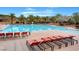 Resort-style community pool area with lounge chairs, palm trees, and clear blue water at 11 Morninglow Pass, Henderson, NV 89052