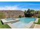 Private pool and spa boasts manicured artificial grass and unobstructed desert views beyond at 11 Morninglow Pass, Henderson, NV 89052