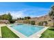Stunning pool area features a built-in spa, desert views, and lush landscaping at 11 Morninglow Pass, Henderson, NV 89052