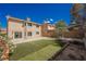 Spacious backyard with well-maintained lawn, patio area, and charming landscaping, ideal for outdoor activities at 111 Pomelo Ct, Henderson, NV 89074