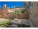 A backyard with a sun shade, tiered brick landscaping, and artificial turf for low-maintenance outdoor living at 111 Pomelo Ct, Henderson, NV 89074