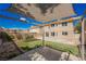 Home exterior showing a covered patio, artificial turf, and well-maintained landscaping in a private backyard setting at 111 Pomelo Ct, Henderson, NV 89074