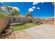 Home exterior featuring a sun shade, artificial turf, brick planters and mature landscaping for outdoor enjoyment at 111 Pomelo Ct, Henderson, NV 89074