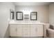 Bathroom featuring double sinks, sleek countertops, and modern lighting fixtures at 111 Pomelo Ct, Henderson, NV 89074