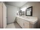 Bathroom vanity featuring double sinks, sleek countertops, and modern lighting fixtures at 111 Pomelo Ct, Henderson, NV 89074