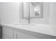 Bright bathroom vanity featuring a modern sink, brushed nickel faucet, and a decorative framed mirror at 111 Pomelo Ct, Henderson, NV 89074