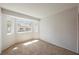Bright bedroom featuring large window with neighborhood views and neutral carpet at 111 Pomelo Ct, Henderson, NV 89074