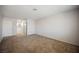 Spacious bedroom with plush carpeting and doorway to bathroom, offering comfort and convenience at 111 Pomelo Ct, Henderson, NV 89074
