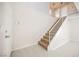 Welcoming entryway with wood-look tile, stairs with carpet runner, and access to the upper level at 111 Pomelo Ct, Henderson, NV 89074