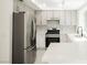 Modern kitchen with stainless steel appliances, granite countertops, and white cabinetry, ready for cooking at 111 Pomelo Ct, Henderson, NV 89074