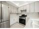 Updated kitchen featuring stainless steel appliances and modern white cabinetry at 111 Pomelo Ct, Henderson, NV 89074