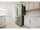 Kitchen area showcasing stainless steel refrigerator, white cabinets and countertops at 111 Pomelo Ct, Henderson, NV 89074