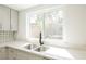 Kitchen sink featuring white countertops, new faucet, and a view of the backyard at 111 Pomelo Ct, Henderson, NV 89074