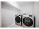 Convenient laundry room showcasing a front load washer and dryer, and storage cabinets above at 111 Pomelo Ct, Henderson, NV 89074